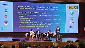 Speakers on stage at conference giving a presentation