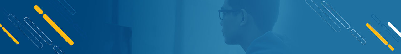 Student wearing glasses looking at computer