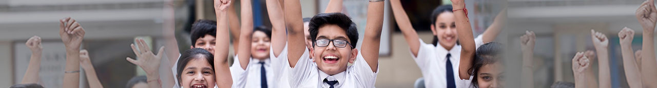 Kids raising hands in classroom